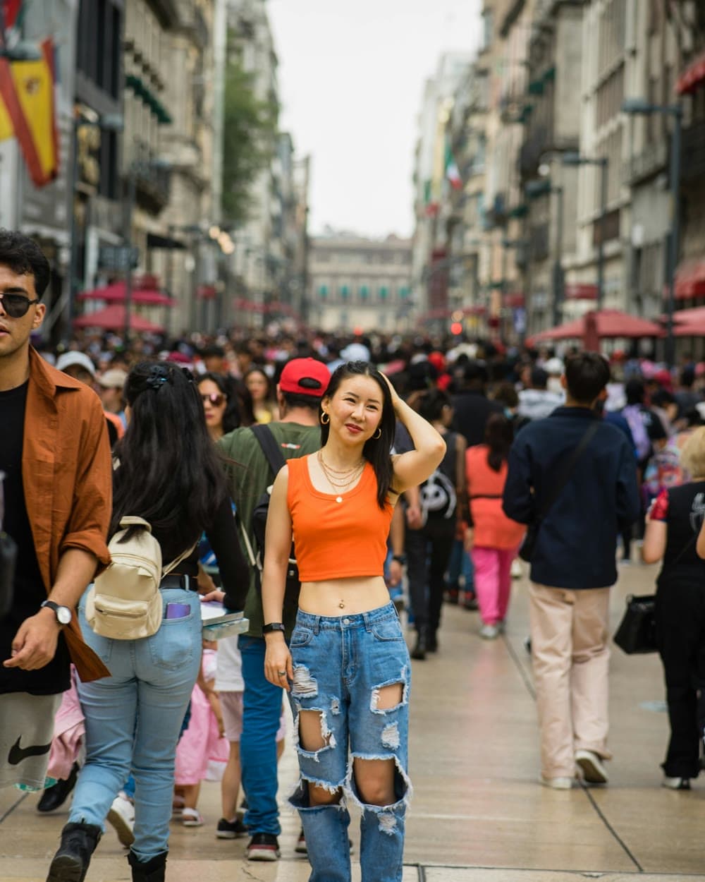 Two people on the same city street corner, each listening to a different tour — parallel narratives.